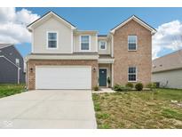 Charming two-story home featuring a brick and vinyl exterior, attached garage, and a well-maintained front lawn at 10020 Caprock Canyon Dr, Indianapolis, IN 46229