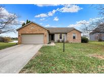 Charming single-story home features a brick facade, attached garage and well-maintained lawn in a suburban neighborhood at 10610 Stillcreek Dr, Indianapolis, IN 46239