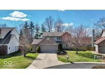 Charming two-story brick home featuring a well-maintained lawn and an attached two-car garage at 1450 Preston Ct, Greenwood, IN 46143