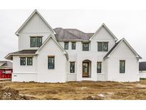 Stunning new construction home with white painted brick and vertical siding and contrasting black window frames at 19909 Windsor Park Blvd, Westfield, IN 46069