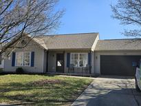 Charming single-story home featuring an attached garage and inviting front porch area perfect for enjoying the outdoors at 2509 Bristlecone Dr, Indianapolis, IN 46217