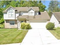 Charming two-story home with attached garage, manicured lawn, and mature trees at 2916 Scottsdale Dr, Indianapolis, IN 46234