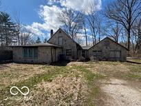 Stone and brick home with a charming vintage aesthetic and a spacious front yard at 326 N Grant St, Brownsburg, IN 46112