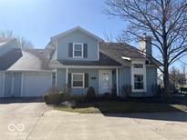 Charming two-story home with a well-maintained front yard and attached garage, perfect for suburban living at 3934 N Lakeside Dr, Muncie, IN 47304