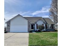 Charming single-Gathering home with a well-manicured lawn, attached two-car garage and brick accents at 4414 Princeton Park Dr, Columbus, IN 47201