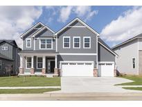 Charming two-story home with gray siding, white trim, well-manicured lawn, and a two car garage at 5314 Noble Crossing W Pkwy, Noblesville, IN 46062
