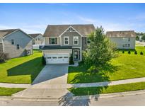 Charming two-story home with a manicured lawn, two car garage and a well-maintained landscape at 6615 School Branch Dr, Brownsburg, IN 46112