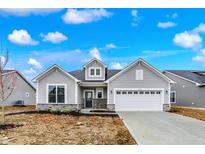 Charming single Gathering home with stone accents, a two-car garage and impeccable curb appeal at 7170 Rose Hill Ave, Brownsburg, IN 46112