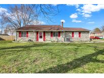 Charming single-story home featuring stone facade, red shutters, and a well-maintained front lawn at 7530 Savannah Dr, Indianapolis, IN 46217