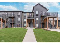 Modern apartment complex showcases beautiful landscaping, private balconies, and exterior stairways at 102 Clarendon Dr # 514, Noblesville, IN 46062