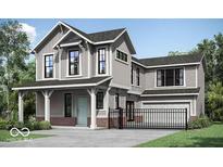 Charming two-story home with a covered porch, modern architectural design and manicured front yard at 13395 Vickery Ridge Dr, Fishers, IN 46037