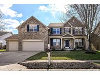 Charming two-story home with stone facade, well-manicured lawn, and a convenient three-car garage at 15898 Bounds Dr, Noblesville, IN 46062