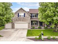 Charming two-story home featuring a stone facade, three-car garage, and well-manicured front yard at 15898 Bounds Dr, Noblesville, IN 46062