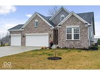 Beautifully designed two-story brick home with a three car garage and a well maintained lawn at 19036 Karyn Ln, Noblesville, IN 46062