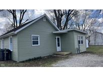 Charming single-story home with light green siding, white trim, and a small front porch entrance at 1904 S Rosemont Ave, Muncie, IN 47302