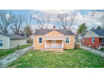 Charming, well-maintained one-story home with a cozy front porch and a well-manicured lawn at 1940 N Drexel Ave, Indianapolis, IN 46218