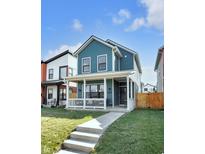Charming two-story home with a covered porch and a well-maintained lawn, perfect for Gathering living at 1945 Carrollton Ave, Indianapolis, IN 46202