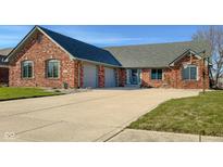 View of the all-brick single-story home with attached garage and basketball hoop on the driveway at 2054 Partridge Dr, Franklin, IN 46131