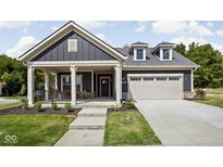 Charming single-Gathering home featuring a two-car garage, covered front porch, and well-maintained landscaping at 2786 Kipling Dr, Carmel, IN 46033