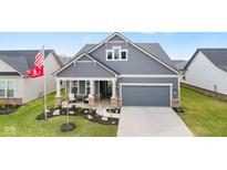 Beautiful single-Gathering home featuring a charming front porch, well-manicured lawn, and attached two-car garage at 3121 Arkle Rd, Westfield, IN 46074