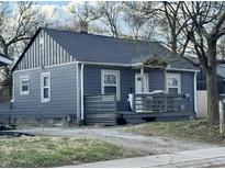 A charming one-story home with gray siding, dark roof, and inviting front porch, perfect for relaxing outdoors at 3422 Hillside Ave, Indianapolis, IN 46218