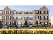 Charming townhomes showcasing a blend of brick and vinyl siding, complemented by neatly landscaped front yards at 3535 Buckner Dr, Westfield, IN 46074
