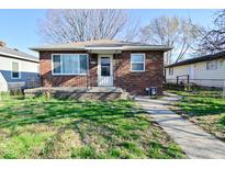 Charming brick home with well-maintained lawn and inviting front porch at 3618 Spann Ave, Indianapolis, IN 46203