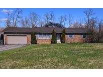 Charming brick ranch home with a large front yard and attached garage at 3922 Dundee Dr, Indianapolis, IN 46237