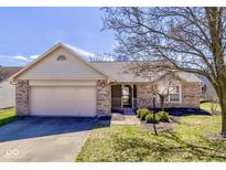 Charming single-story home with a well-manicured lawn and attached two-car garage at 4655 Welton St, Greenwood, IN 46143