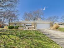 Charming brick ranch home featuring an attached garage, and a well-maintained front yard at 5449 S 100 W, Anderson, IN 46013