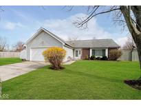 Charming single-story home featuring a well-manicured lawn and attached two-car garage at 8527 Honeysuckle Way, Indianapolis, IN 46256