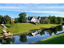 Beautiful waterfront home with lush green lawn and a charming dock at 999 Box Turtle Ct, Columbus, IN 47201