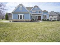 Charming two-story home with blue siding, manicured lawn, and stone accents for added curb appeal at 10053 Soaring Eagle Ln, Fishers, IN 46055