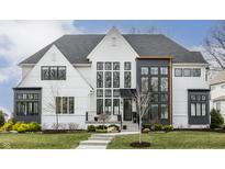 Stunning two-story home with a manicured lawn, complemented by black trimmed windows and a contemporary design at 11003 Holliday Farms Blvd, Zionsville, IN 46077