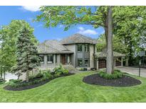 Beautiful two-story home with stone accents, lush landscaping, and a well-maintained front yard at 11941 Sand Dollar Cir, Indianapolis, IN 46256