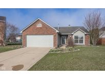 Charming single-story brick home with a well-maintained lawn and attached two-car garage at 13985 Mary Ct, Fishers, IN 46038