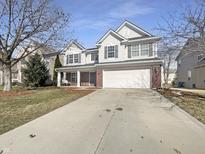 Charming two-story home featuring a brick and vinyl exterior, attached two-car garage, and a well-manicured front yard at 14466 Chapelwood Ln, Fishers, IN 46037