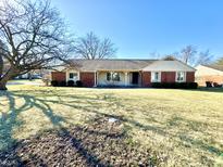 Charming single-story home with brick facade, mature tree, and well-maintained lawn at 1645 Woodview Ln, Anderson, IN 46011