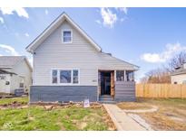 Charming two-story home with gray siding, black brick accents, and a quaint front yard at 1815 Pearl St, Anderson, IN 46016
