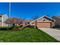 Charming single-story home with a well-manicured lawn and a two-car garage, blending classic design with modern convenience at 1820 Electric Ave, Indianapolis, IN 46260