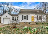View of the front exterior of the home, showcasing a yellow front door at 214 W Elbert St, Indianapolis, IN 46217
