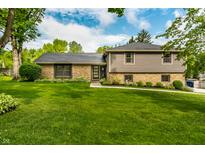 Charming home with manicured lawn, stone accents, and gray siding, offering great curb appeal at 224 Brierley Way, Carmel, IN 46032