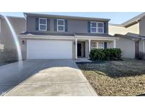 Charming two-story home with a two car garage and gray siding at 2350 Bridlewood Dr, Franklin, IN 46131