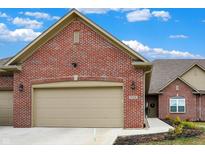 Charming single-Gathering home features a red brick exterior, attached garage, and manicured landscaping at 2753 Stones Bay Dr, Greenwood, IN 46143