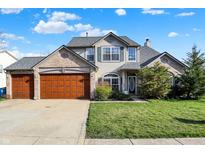 Charming two-story home featuring a two-car garage, well-manicured lawn, and inviting front entrance at 5347 Creekbend Dr, Carmel, IN 46033