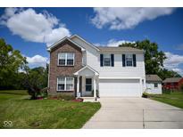 Charming two-story home featuring brick and vinyl siding, a two-car garage, and landscaped front yard at 746 Greene Ct, Avon, IN 46123
