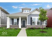 Charming single-Gathering home with gray siding, brick accents, black shutters, and a well-manicured front yard at 9198 Anthem Ave, Plainfield, IN 46168