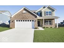 Charming two-story home with brick accents, a two-car garage, and a well-manicured lawn at 943 Rushmore Dr, Pittsboro, IN 46167