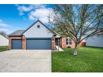 Charming two-story brick and siding home with attached two car garage and a well-manicured front lawn at 12702 Slippery Rock Rd, Indianapolis, IN 46236
