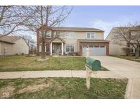 Charming two-story home with a well-manicured lawn, a two-car garage, and a brick and siding exterior at 15860 Symphony Blvd, Noblesville, IN 46060